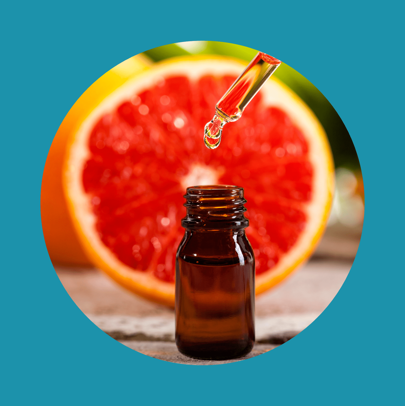 Grapefruit Essential Oil on green leaves background
