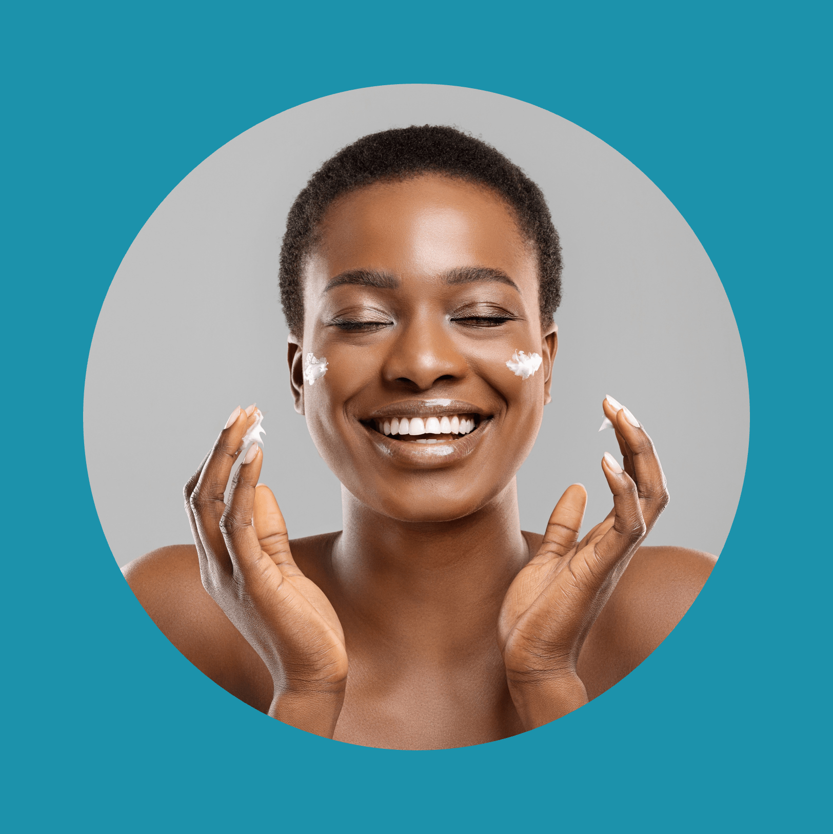Beautiful afro woman applying cream on her cheeks and sincerely smiling